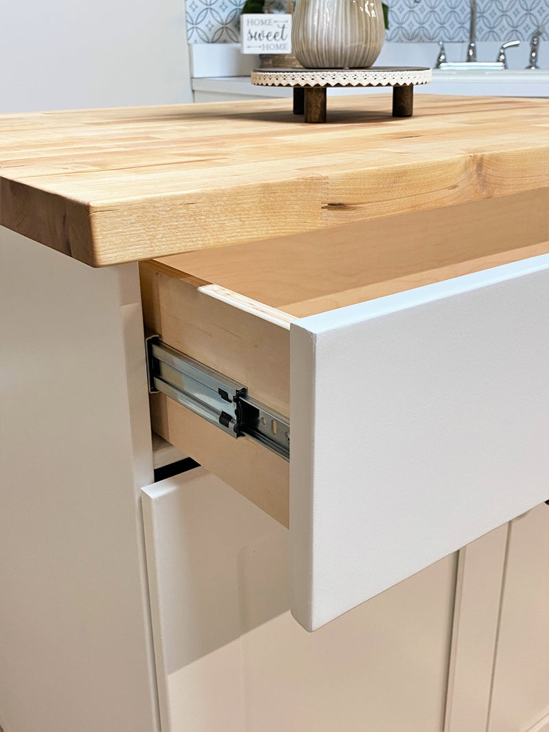 Island in white with a butcher block top