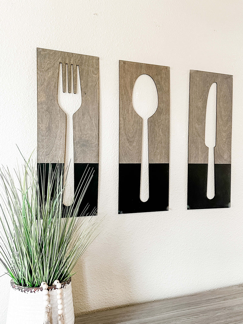 Fork, spoon, and knife wall decor in dark charcoal with aged barrel stain