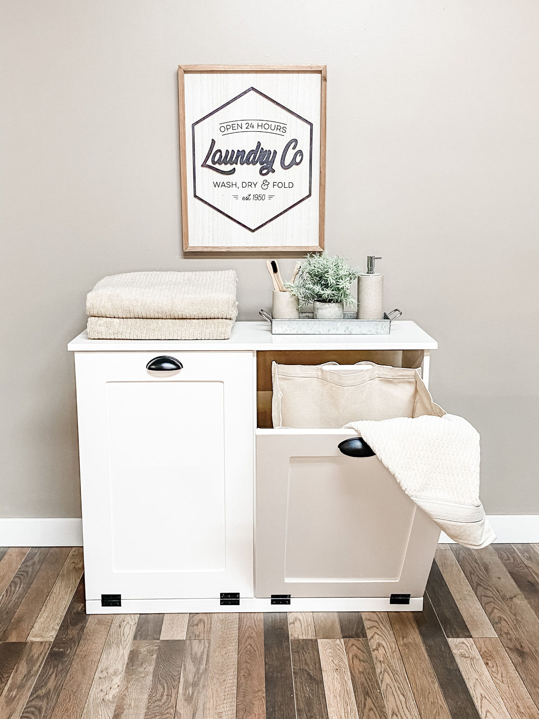 white tilt out laundry hamper with removable canvas bag.