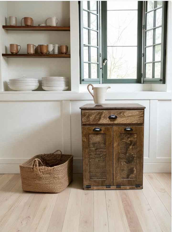 Counter high, slim trash cabinet design. Includes a storage drawer in dark brown