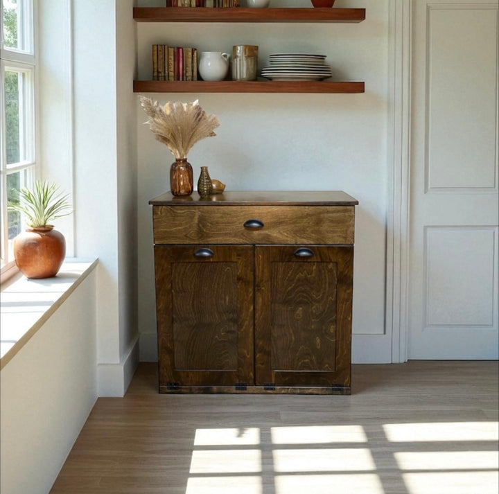 Freestanding trash cabinet with a storage drawer in dark brown stain