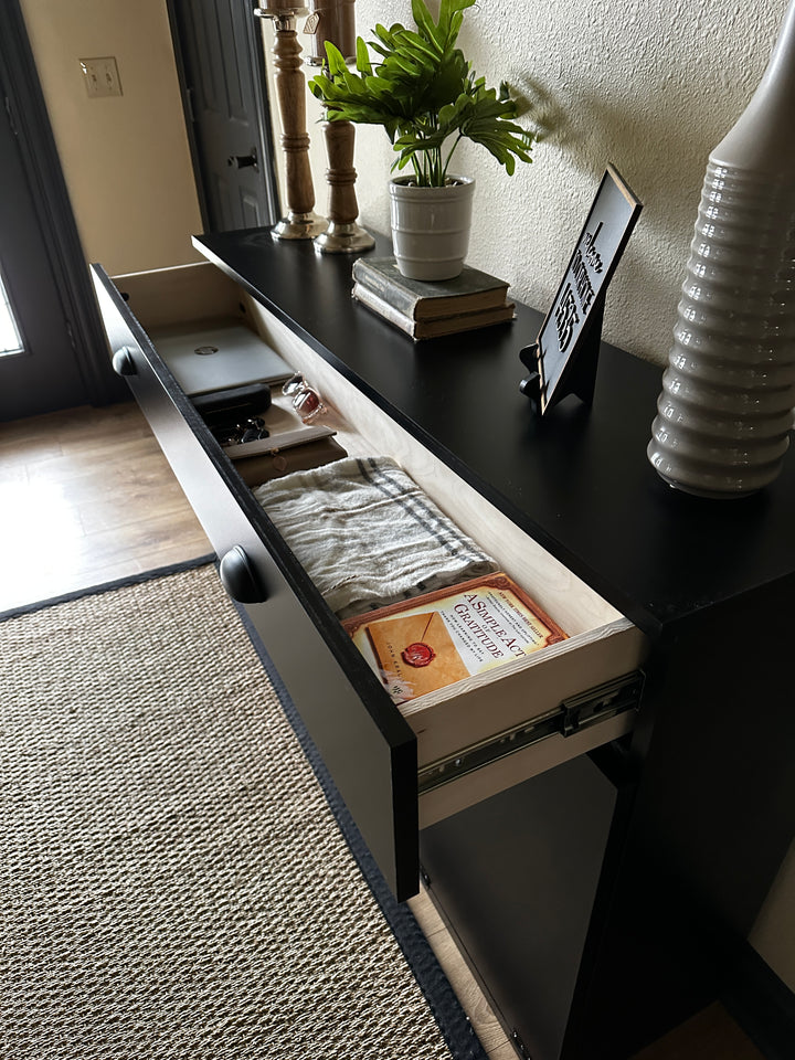 Triple cabinet trash bin with a storage drawer in black stain