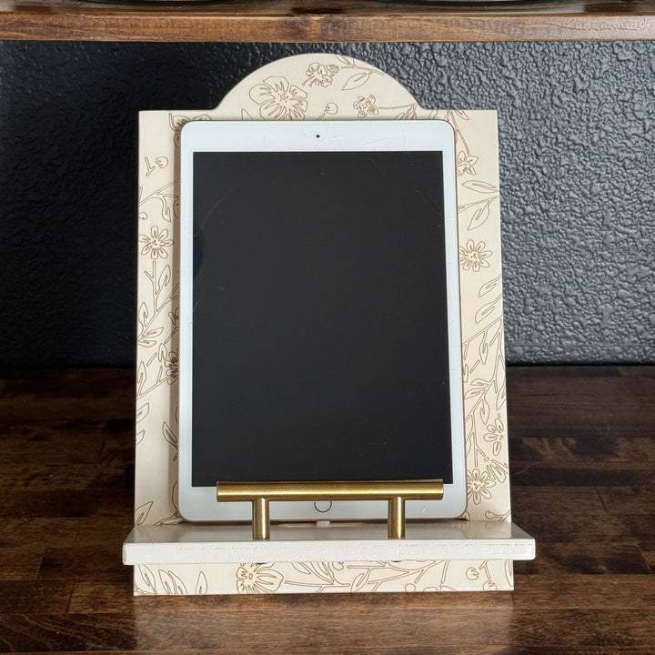 Decorative tablet stand with a tablet on a wooden surface