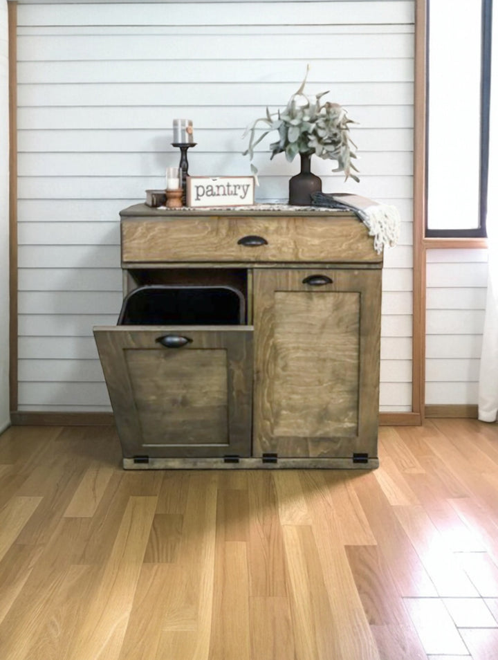 Counter tall hidden trash cabinet with a storage drawer in aged barrel stain