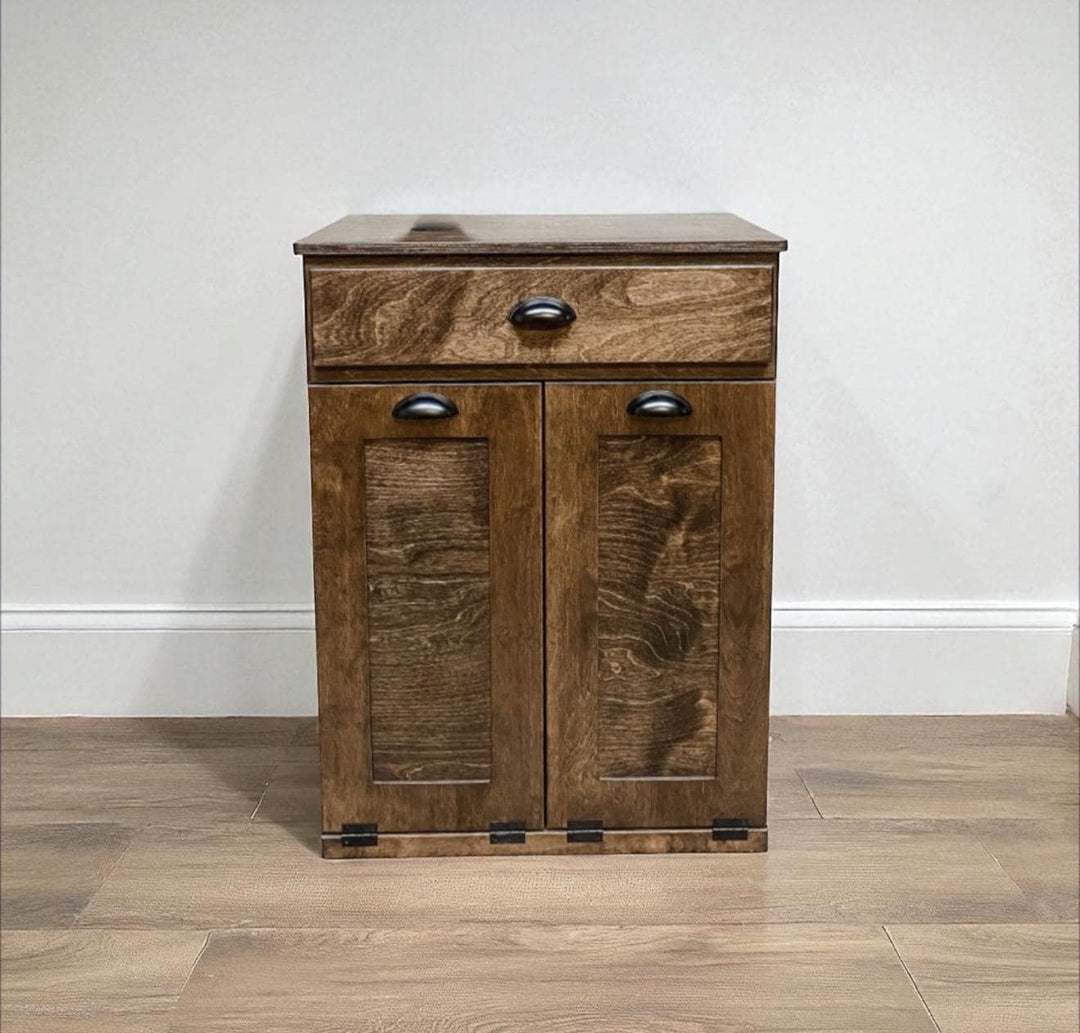 Counter high, slim trash cabinet design. Includes a storage drawer in dark brown