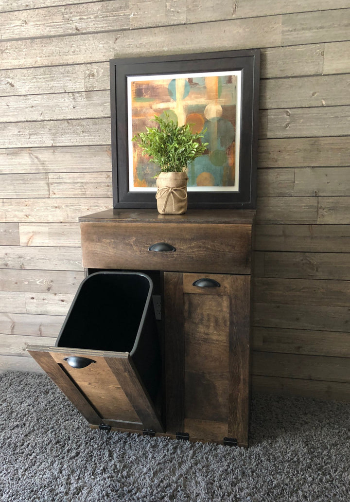 Counter high, slim trash cabinet design. Includes a storage drawer in dark brown