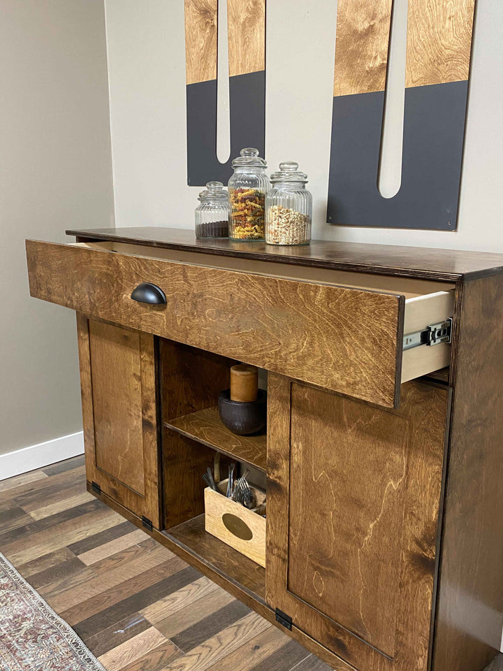 Triple tilt-out with a storage drawer and open shelving in warm brown stain