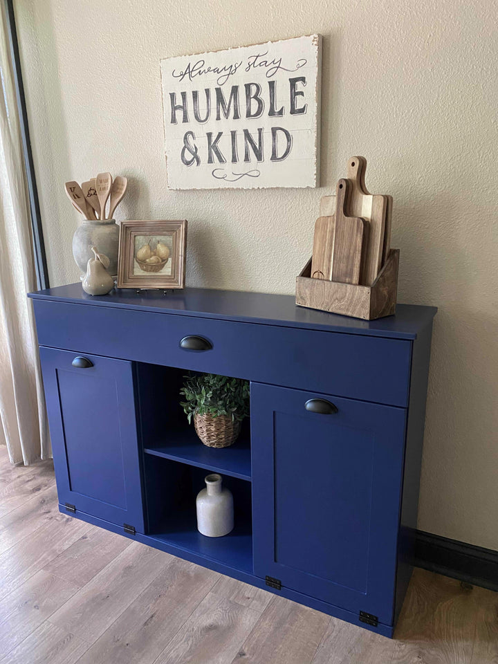 Triple trash cabinet with a storage drawer and open shelving in blue