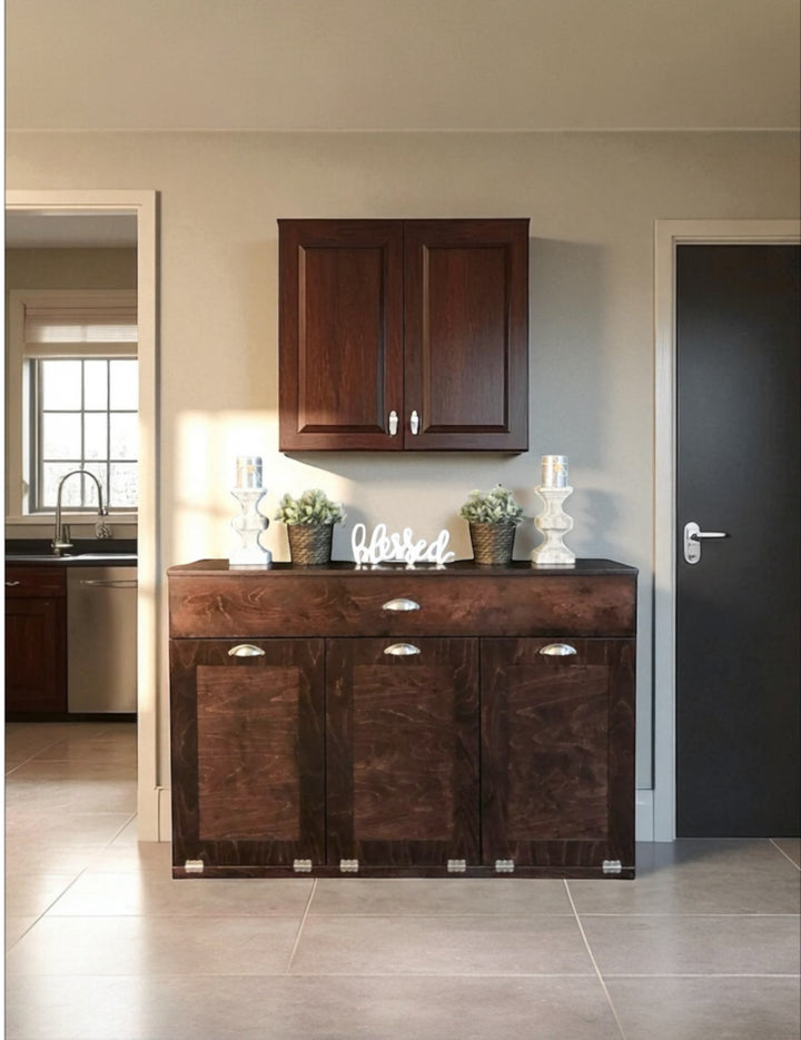 Freestanding Triple Trash cabinet with a storage drawer stained in red oak