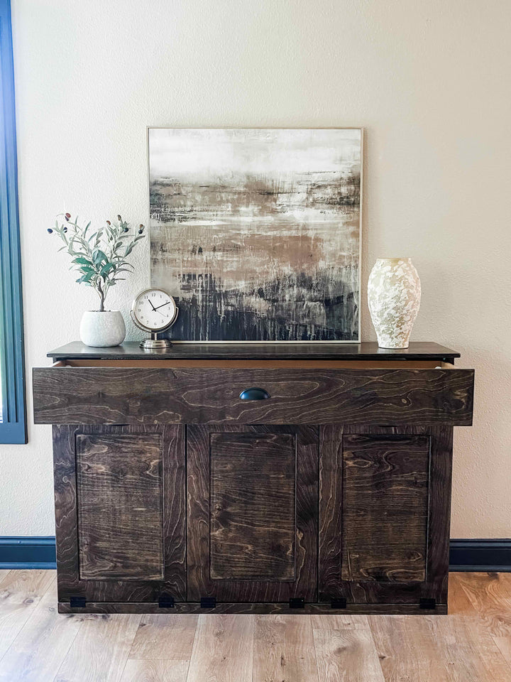 Furniture style triple tilt out trash cabinet in dark brown with a storage drawer