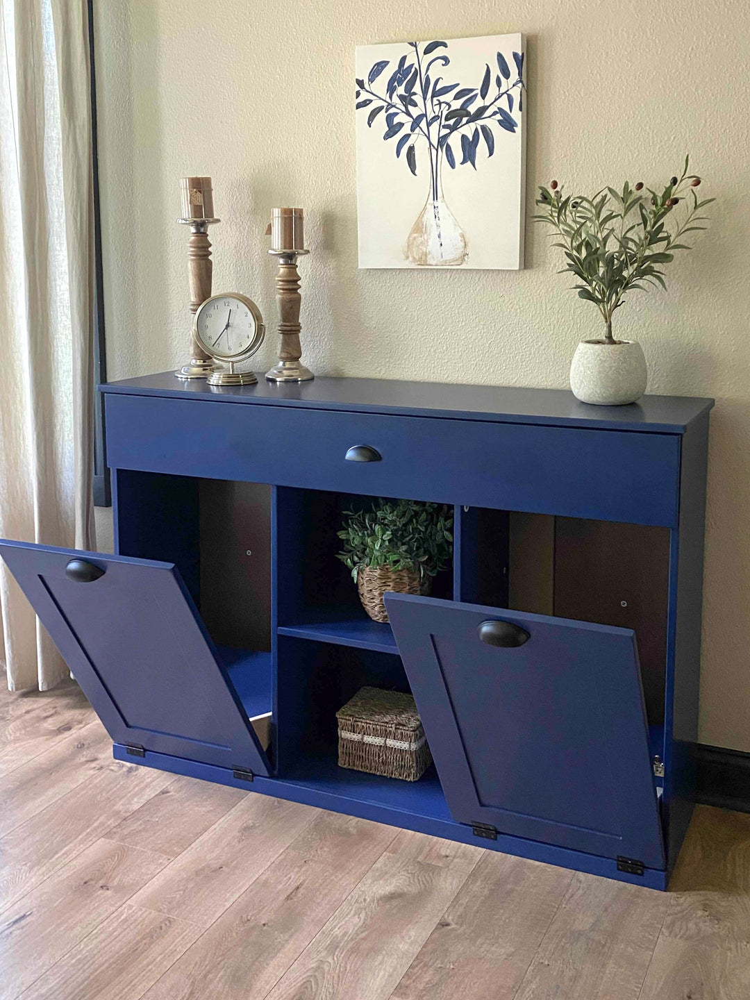 Triple trash cabinet with a storage drawer and open shelving in blue
