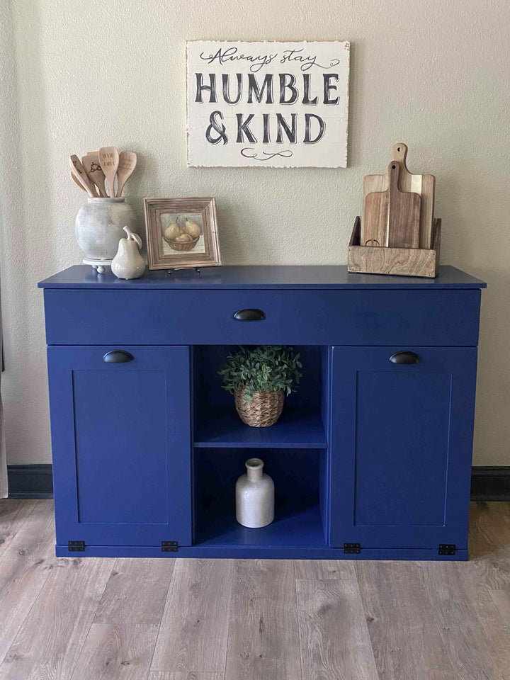 Triple trash cabinet with a storage drawer and open shelving in blue