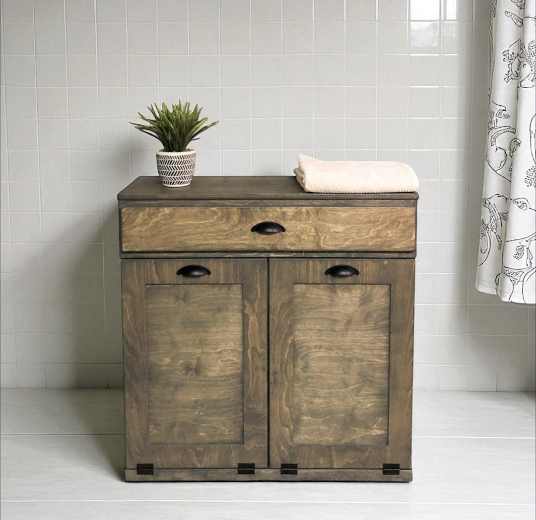 Double laundry hamper with a storage drawer in aged barrel stain