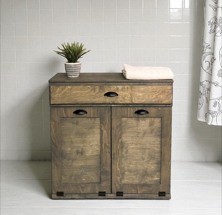 Double laundry hamper with a storage drawer in aged barrel stain