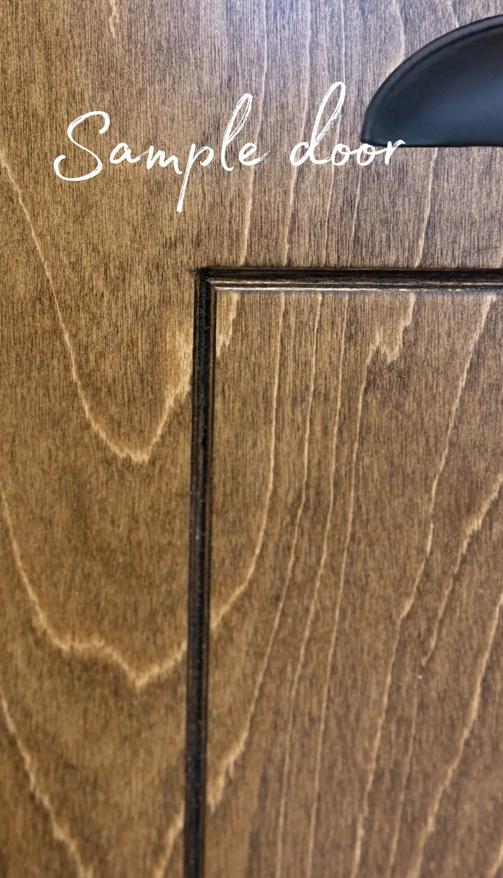 Freestanding Triple Trash cabinet with a storage drawer stained in red oak