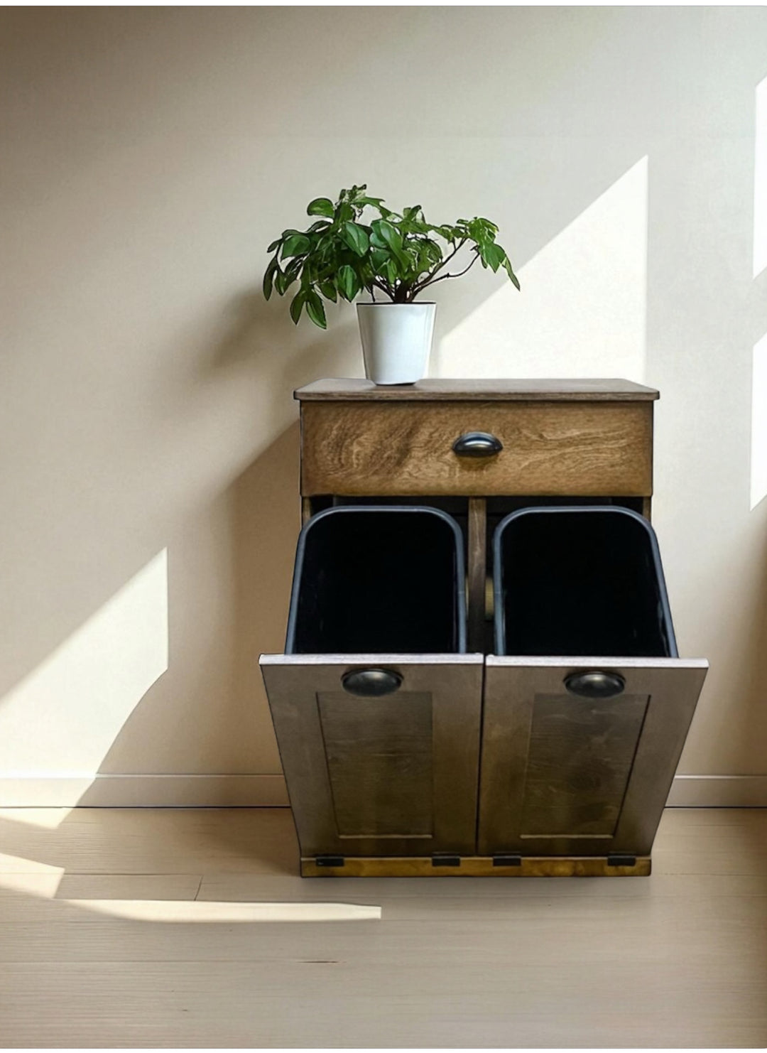 Counter high, slim trash cabinet design. Includes a storage drawer in dark brown