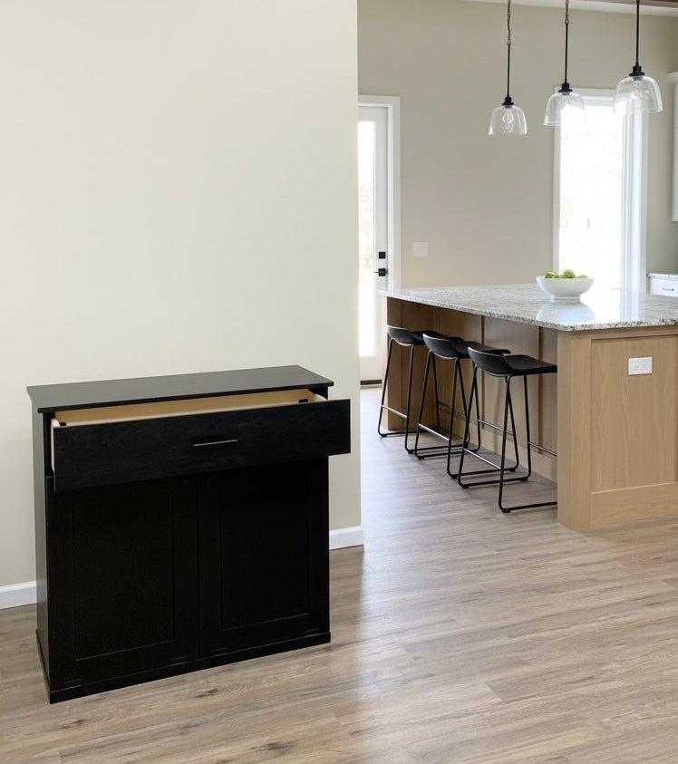 Free standing hidden trash cabinet with a storage drawer in black stain