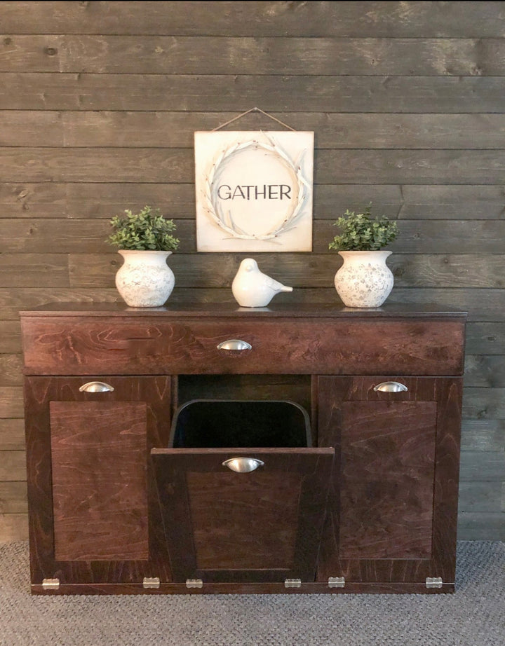 Freestanding Triple Trash cabinet with a storage drawer stained in red oak