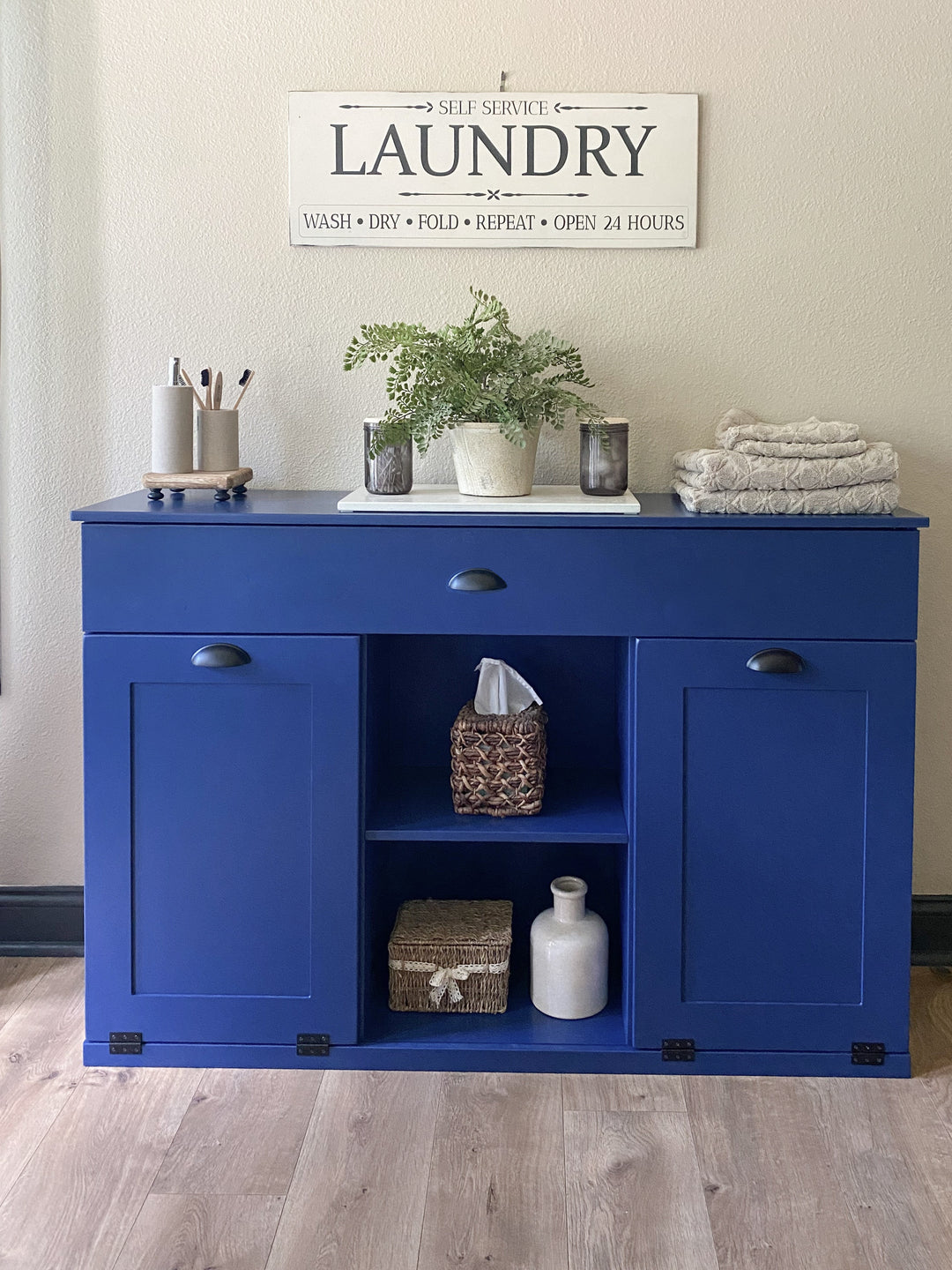3 bin laundry with a storage drawer and open shelving in blue