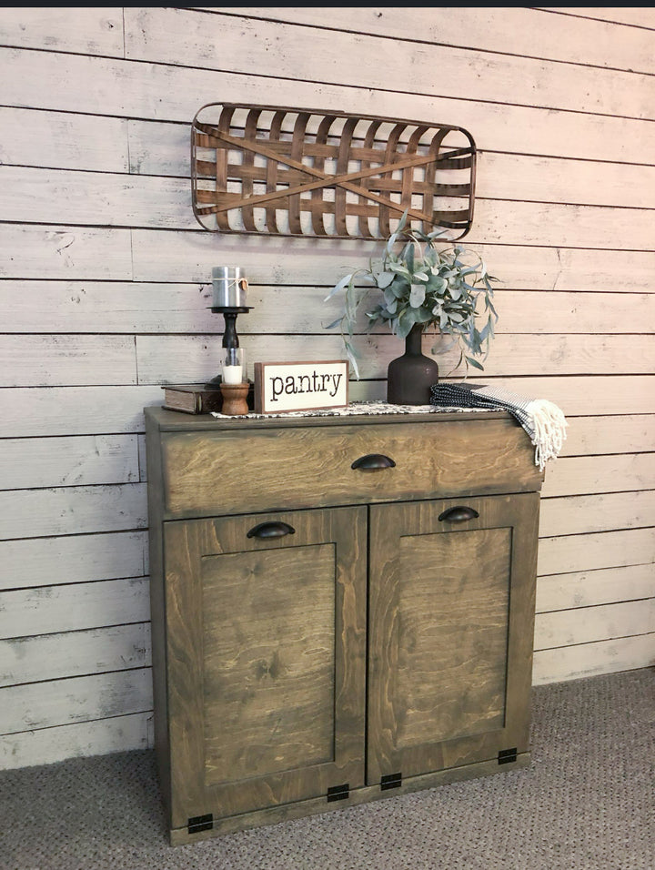 Counter tall hidden trash cabinet with a storage drawer in aged barrel stain