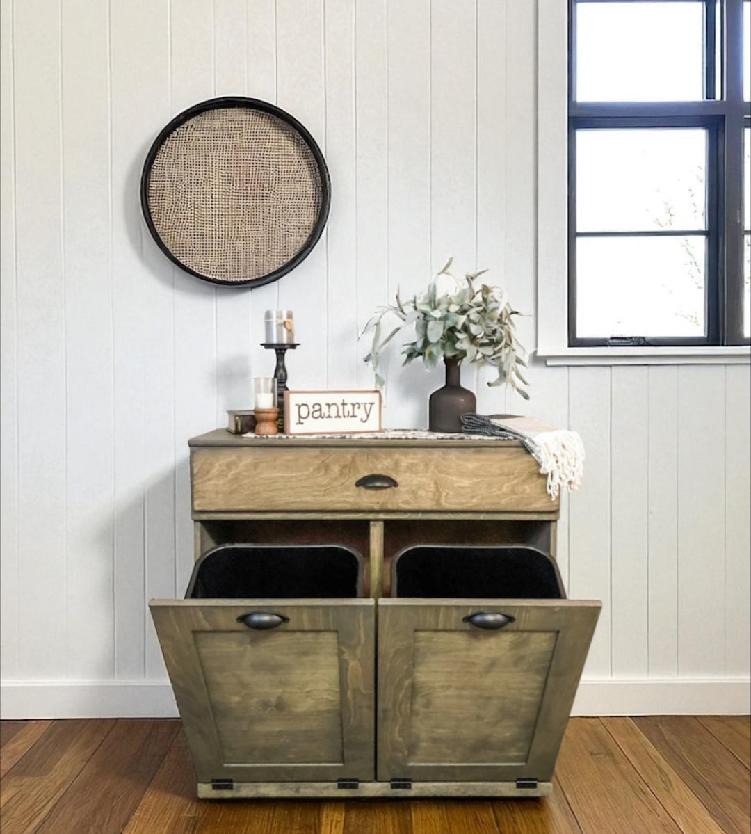 Counter tall hidden trash cabinet with a storage drawer in aged barrel stain