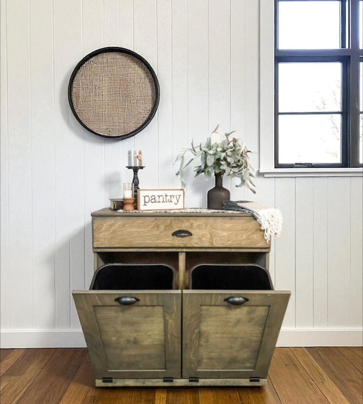 Counter tall hidden trash cabinet with a storage drawer in aged barrel stain