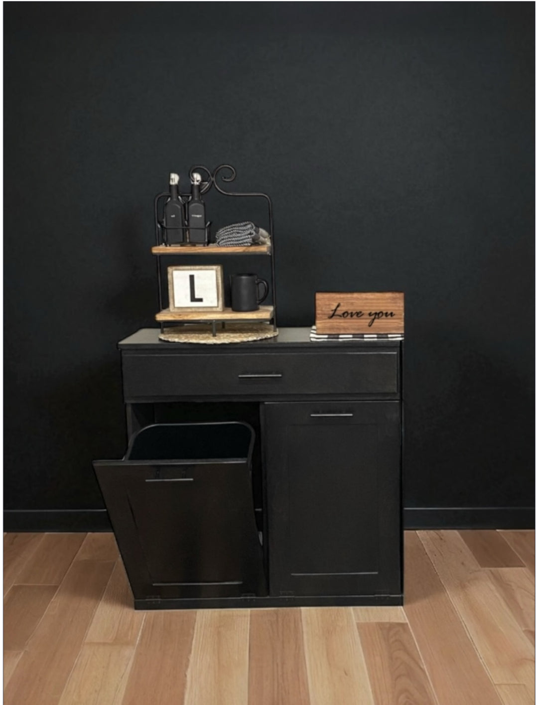 Free standing hidden trash cabinet with a storage drawer in black stain