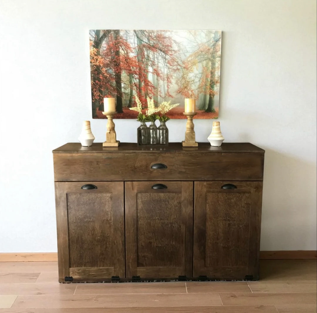 Triple tilt out trash cabinet with storage drawer in warm brown stain