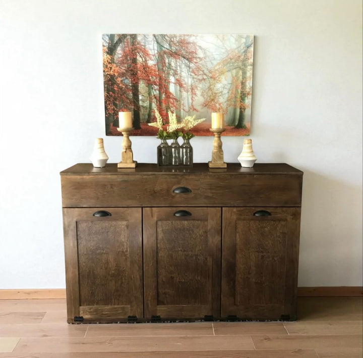 Triple tilt out trash cabinet with storage drawer in warm brown stain