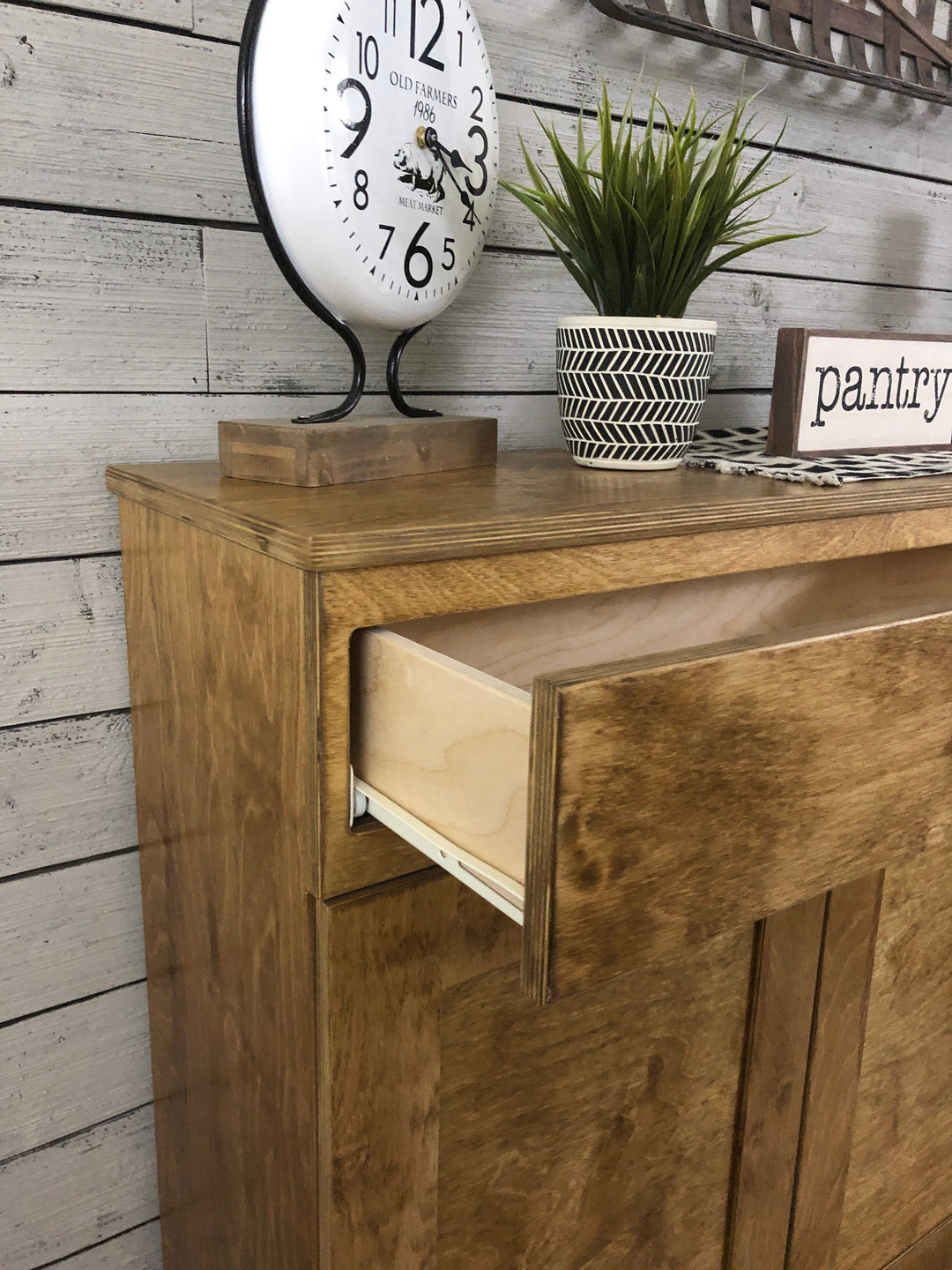 Handmade triple trash cabinet with storage drawer in golden oak stain