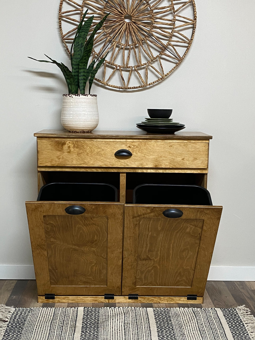 Double style trash cabinet with a storage drawer in golden oak stain