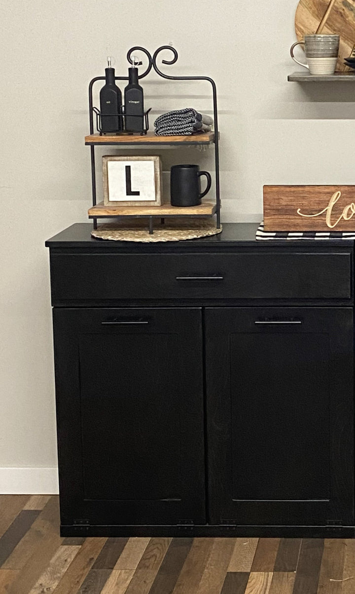 Free standing hidden trash cabinet with a storage drawer in black stain