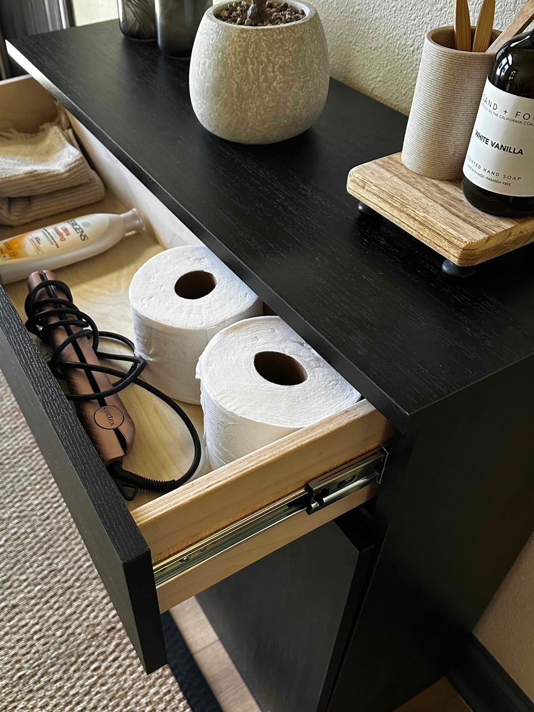 Furniture style laundry with a storage drawer in black stain