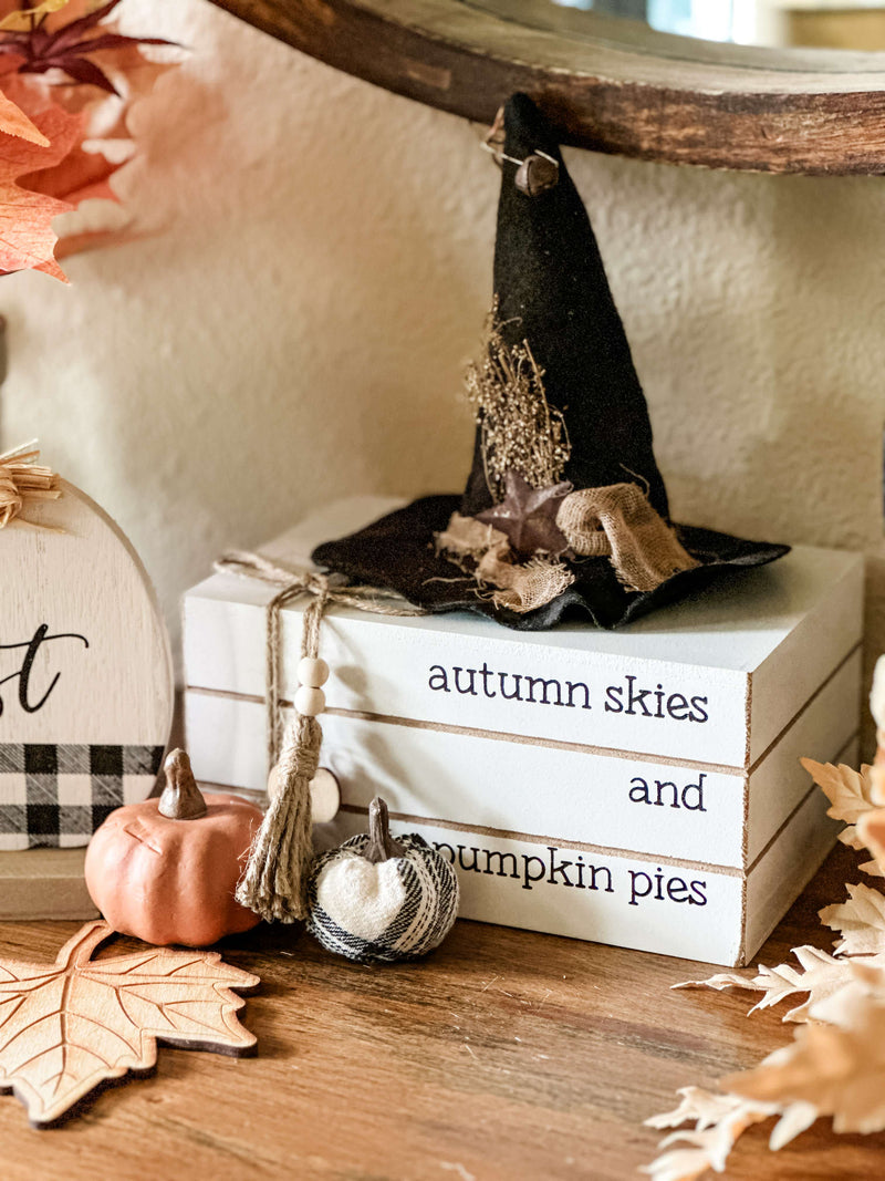 Autumn skies and pumpkin pies stacked books