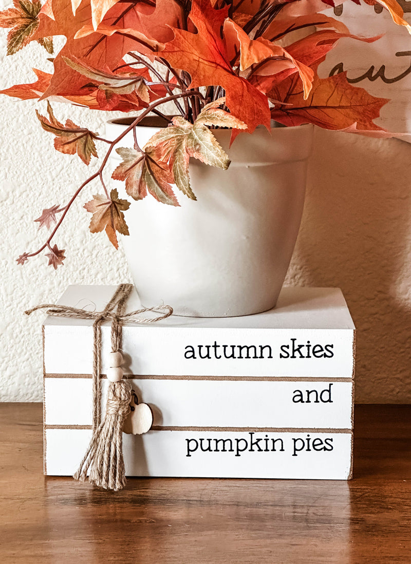 Autumn skies and pumpkin pies stacked books