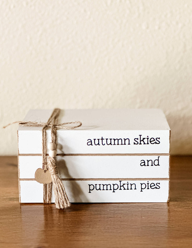 Autumn skies and pumpkin pies stacked books