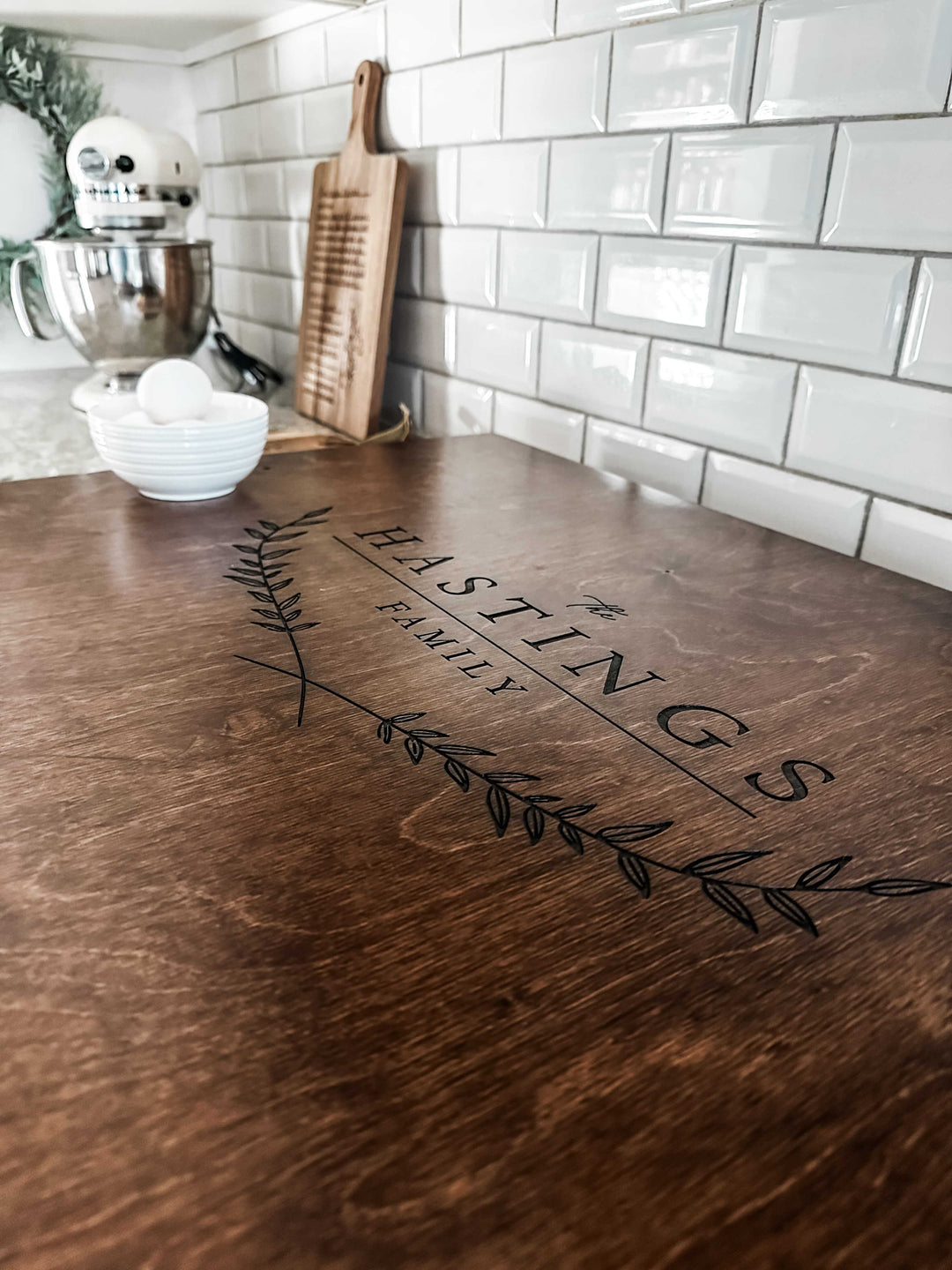 Personalized family name stove cover, warm brown + dark script "Hastings"