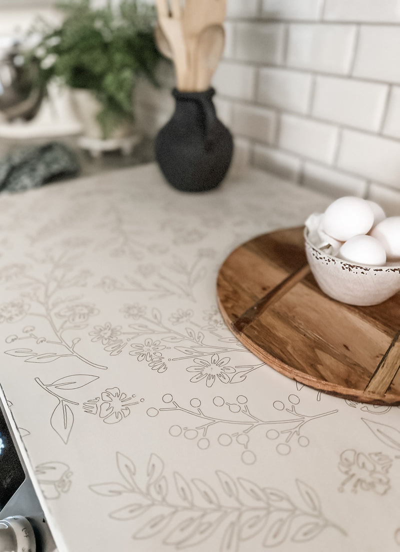 Engraved floral pattern stove cover, ivory distressed