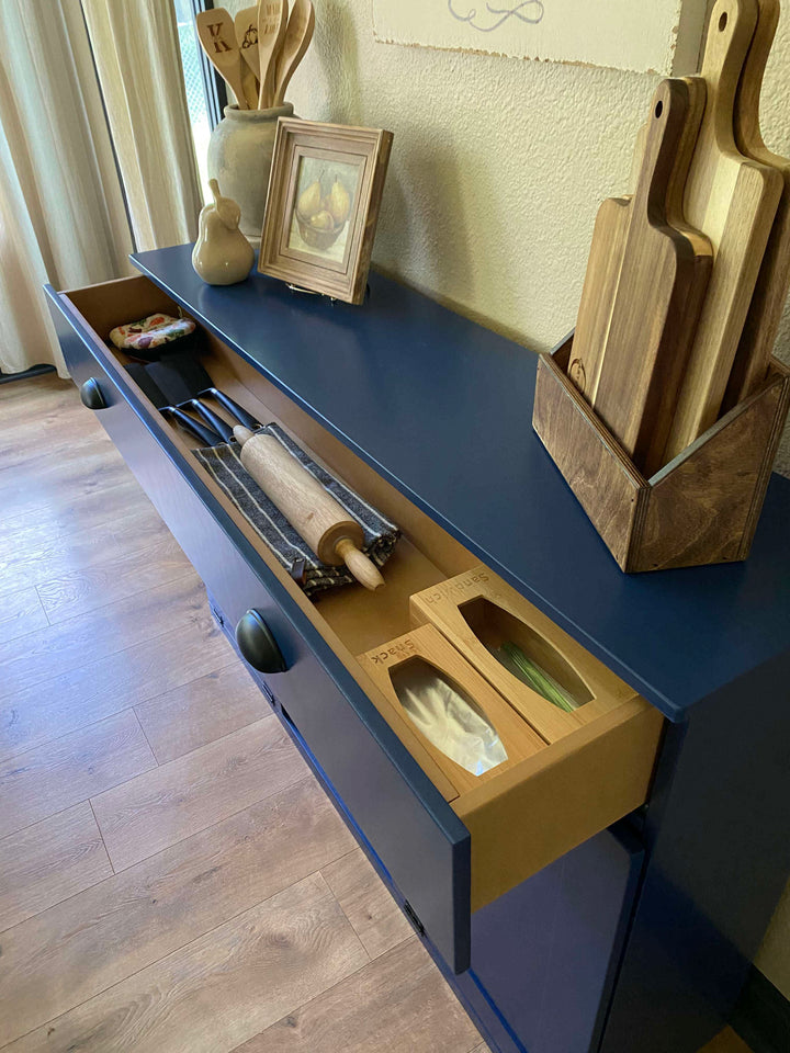 Triple trash cabinet with a storage drawer and open shelving in blue