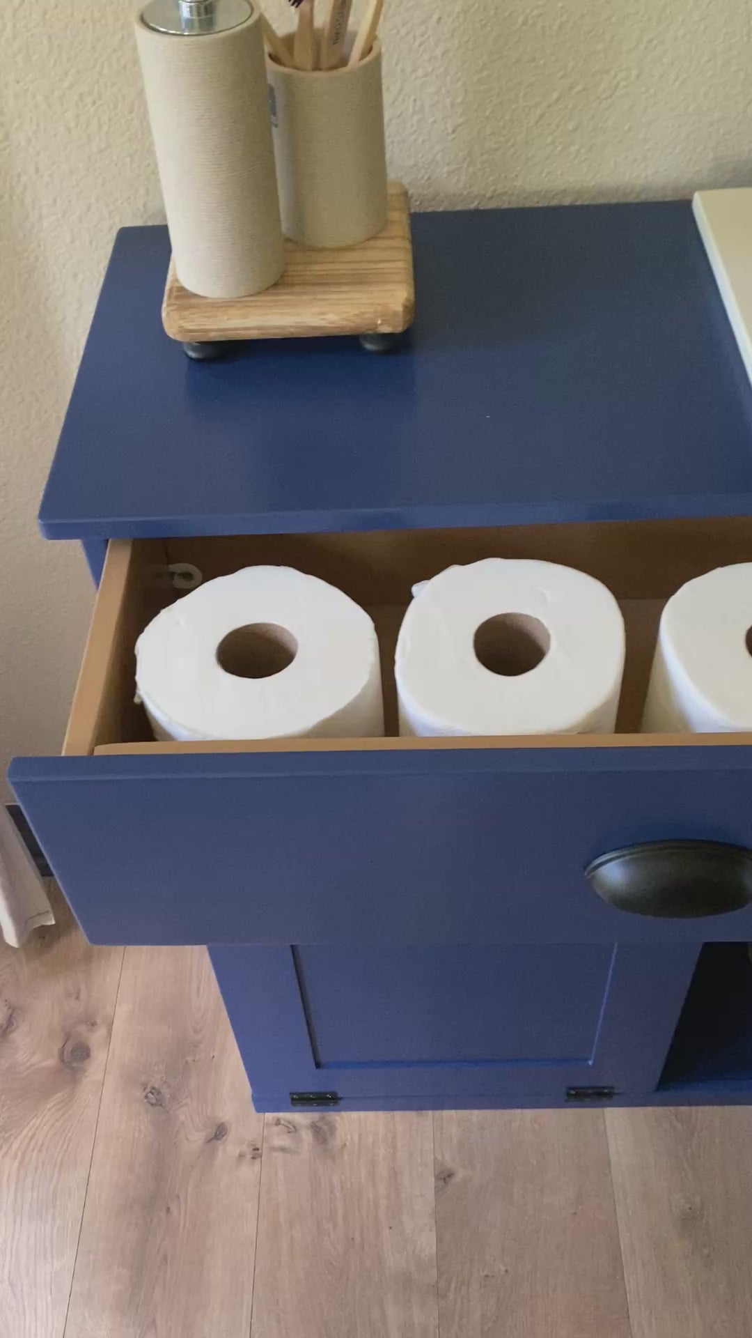 3 bin laundry with a storage drawer and open shelving in blue