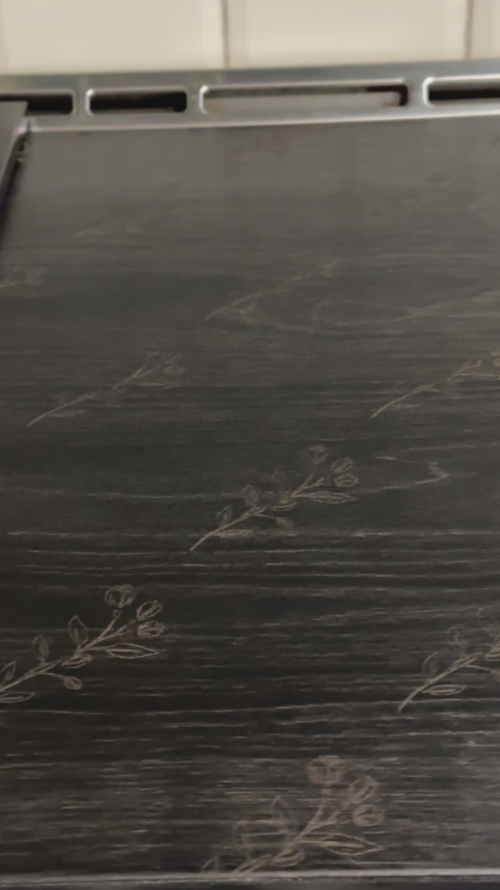 Floral pattern stove cover in black stain