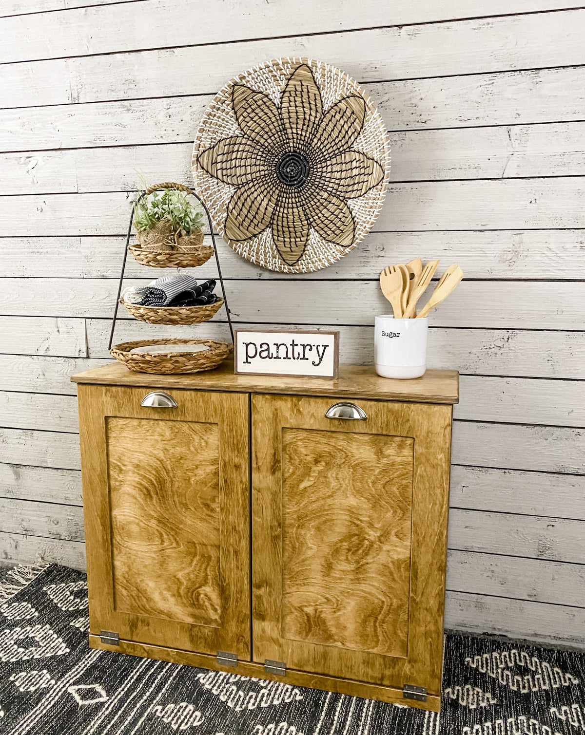 Golden oak double size tilt out trash bin.  Handle options are gold, silver, or black. Panel options are cedar look panel, chalkboard, barn metal, or flat front.