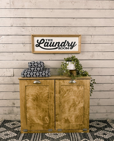 Double size golden oak tilt out laundry hamper.  Handle options are gold, silver, or black. Panel options are cedar look panel, chalkboard, barn metal, or flat front.