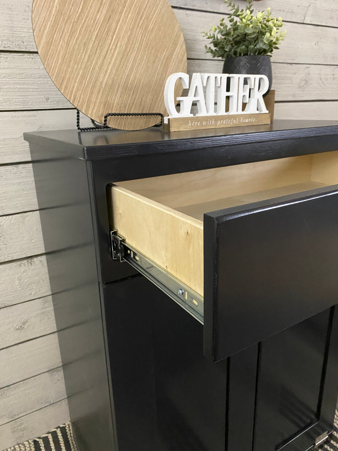 Slim style double trash cabinet with a storage drawer in black stain