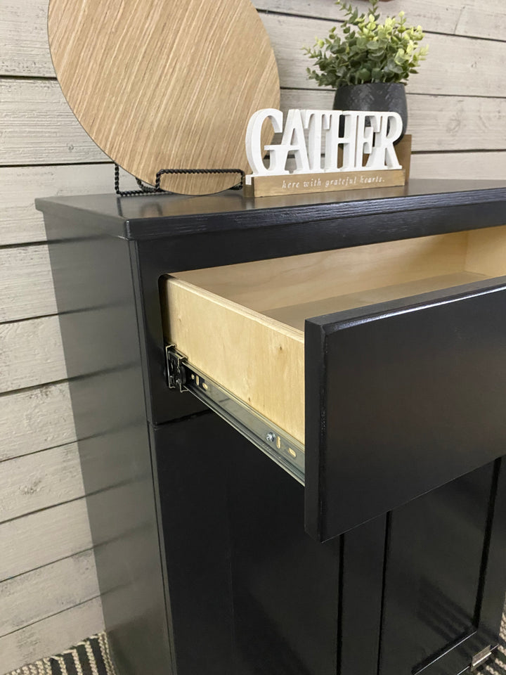 Slim style double trash cabinet with a storage drawer in black stain