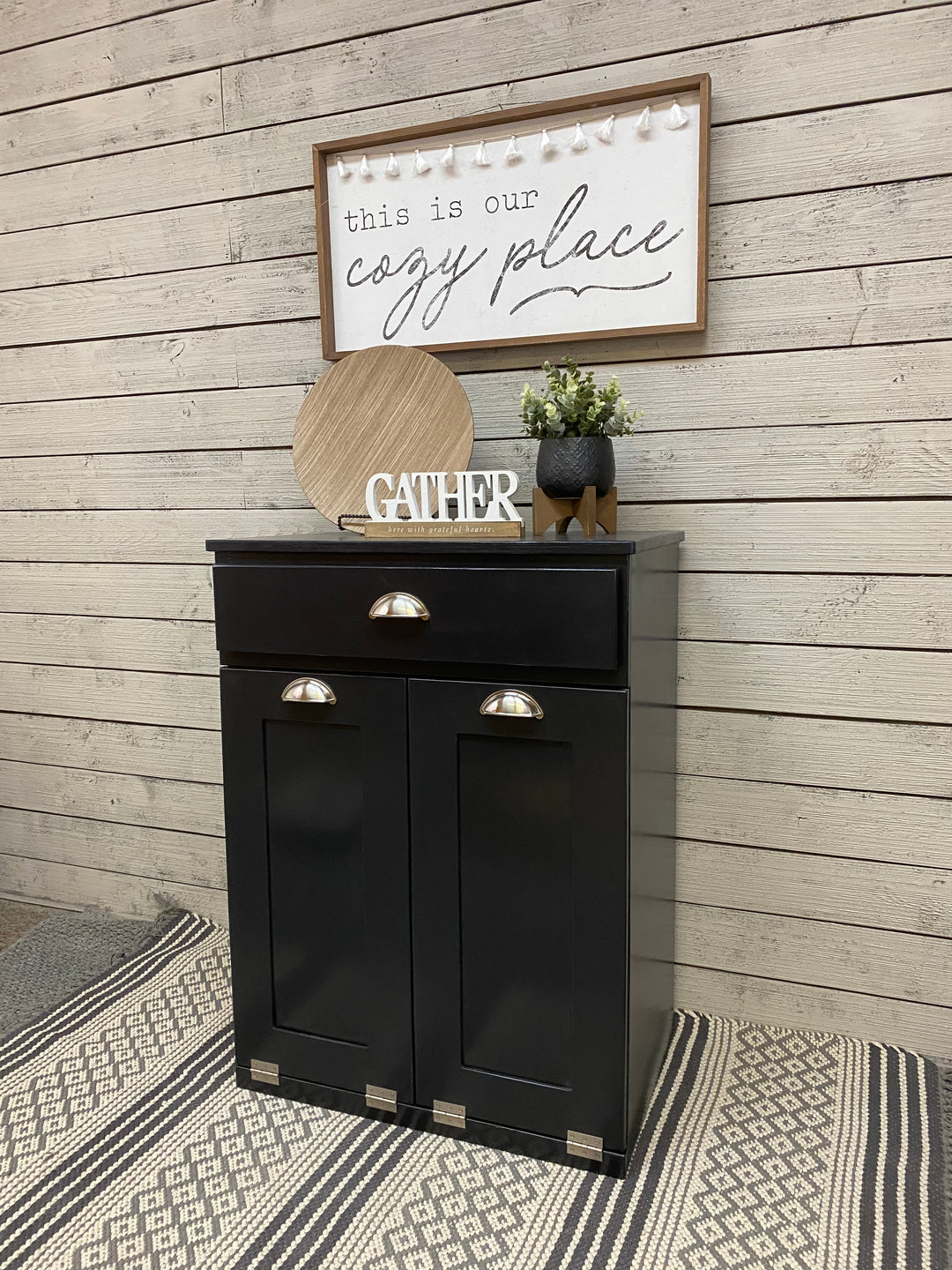 Slim style double trash cabinet with a storage drawer in black stain