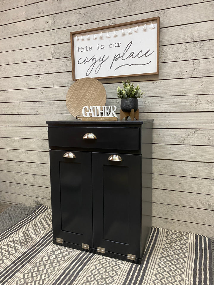 Slim style double trash cabinet with a storage drawer in black stain