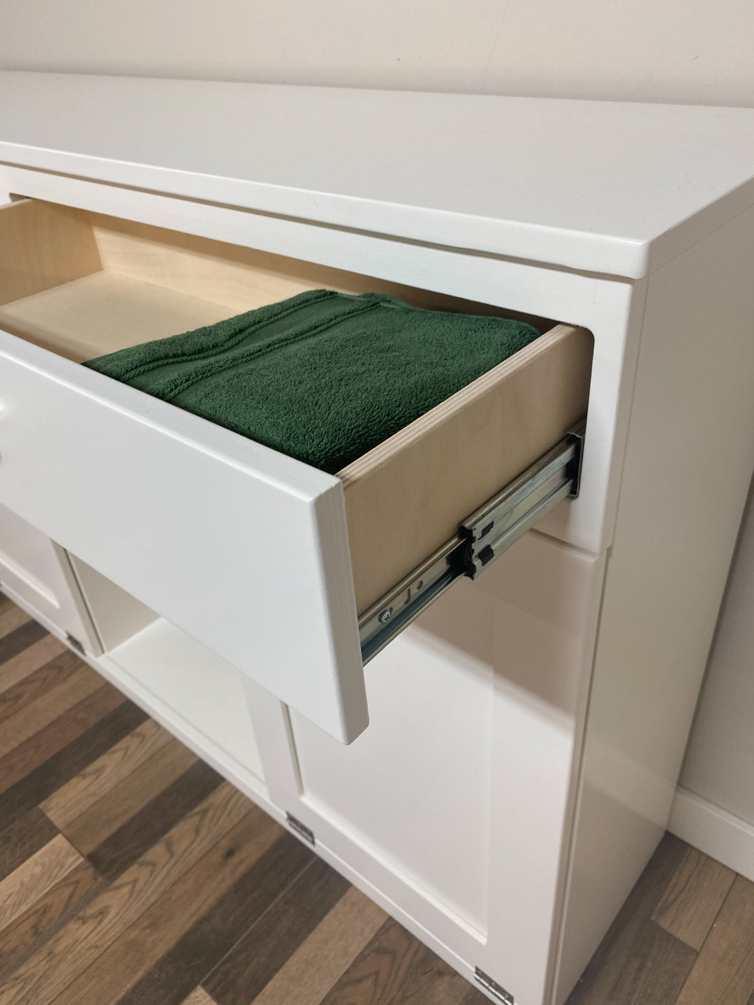 Triple laundry with a storage drawer and open shelving in white