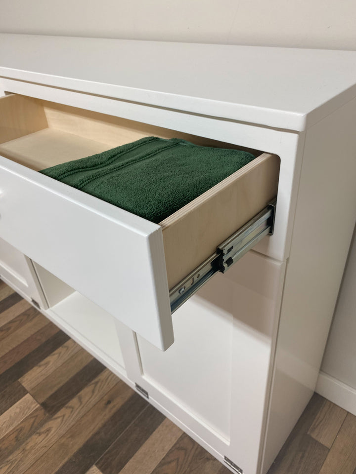Triple laundry with a storage drawer and open shelving in white
