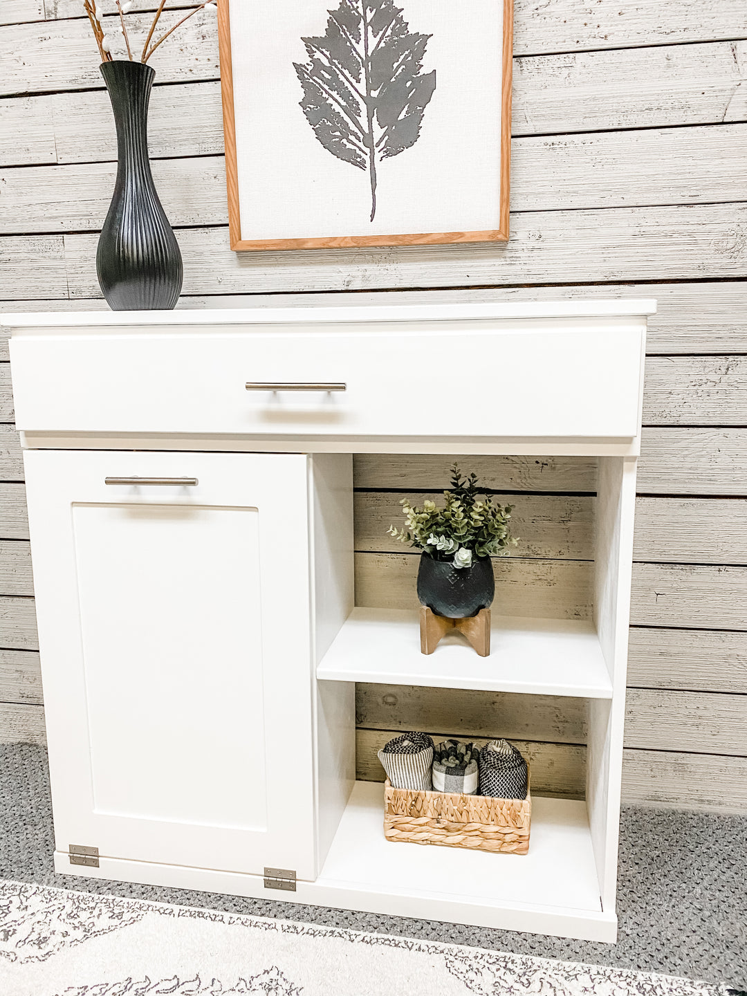 Double size- trash compartment with a storage drawer and open shelving in white